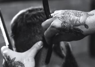 barber is shaving the back of head